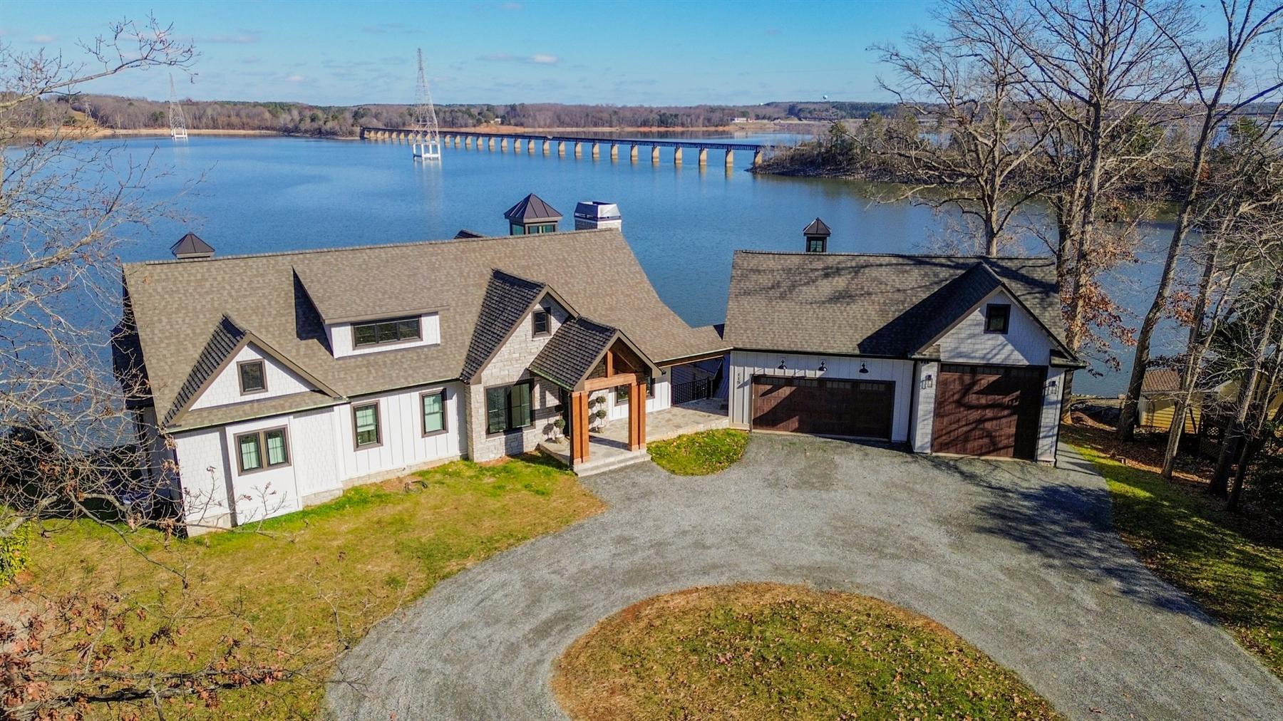 Custom lake house Tony Hirst designed and built, seen from the drive with the water beyond